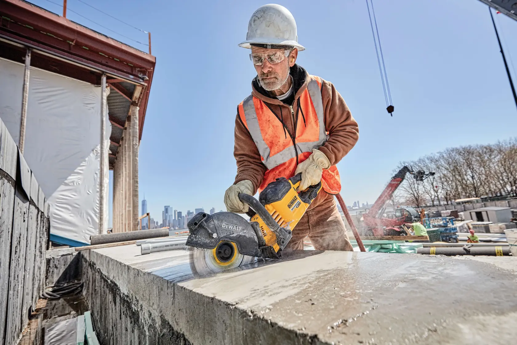 Close up of brushless cordless cut-off saw being used by person on concrete.