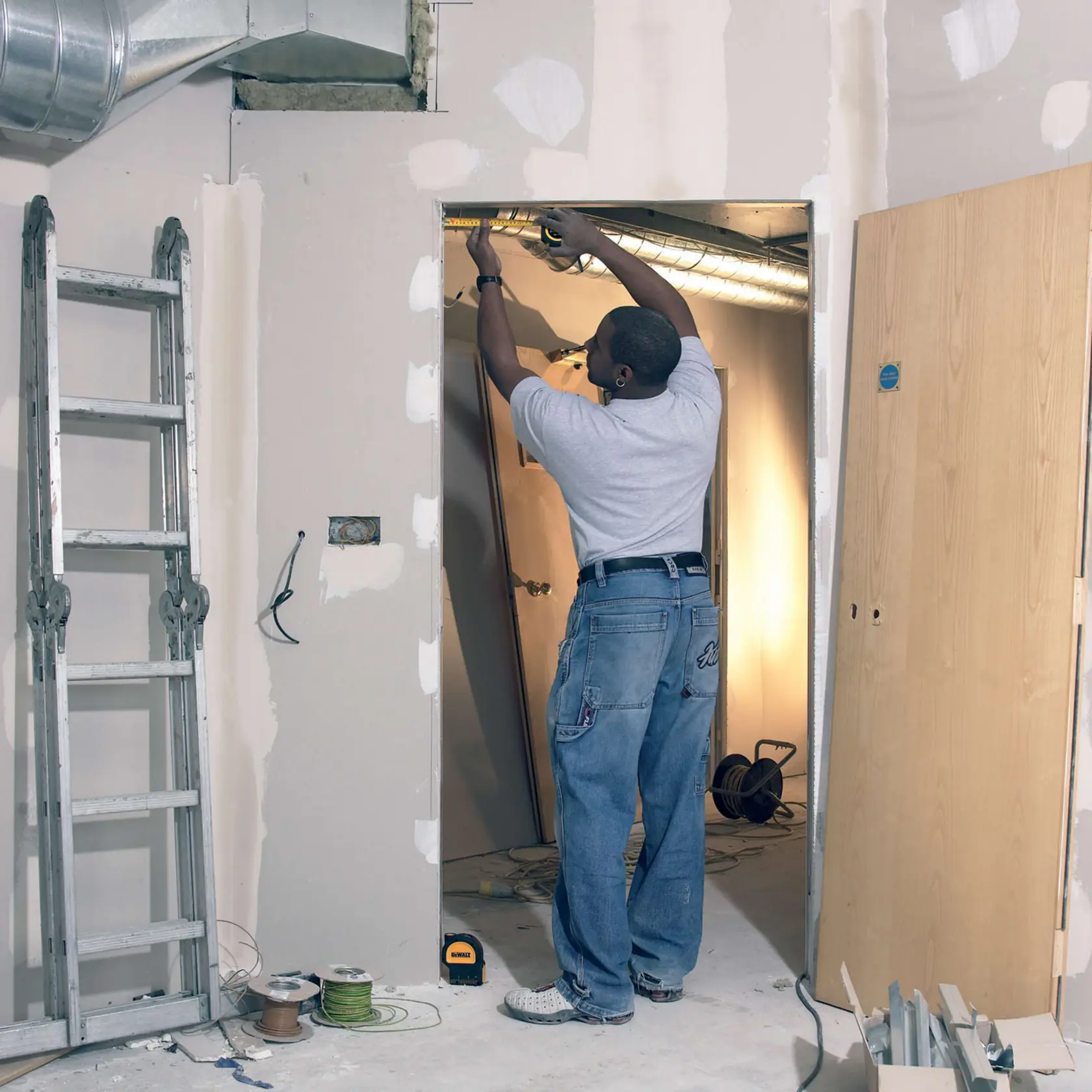 Cross line and plumb spots laser being used by a person.