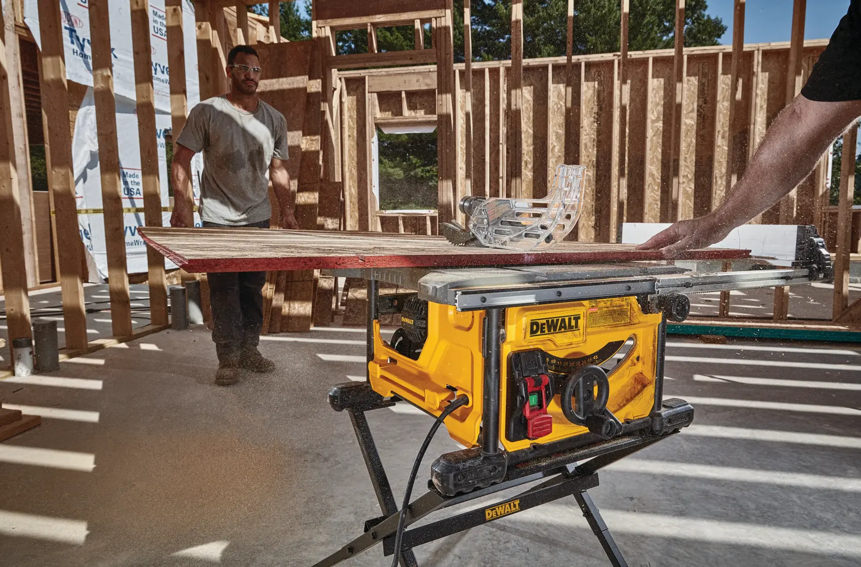 Photo of DEWALT table saw, SKUs DWE7485-GB, DWE7485-QS, DWE7485WS, DWE7485 used on construction site.